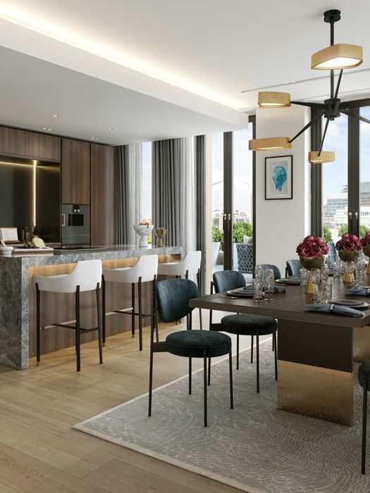 A modern kitchen and dining area featuring a spacious dining table surrounded by stylish chairs.